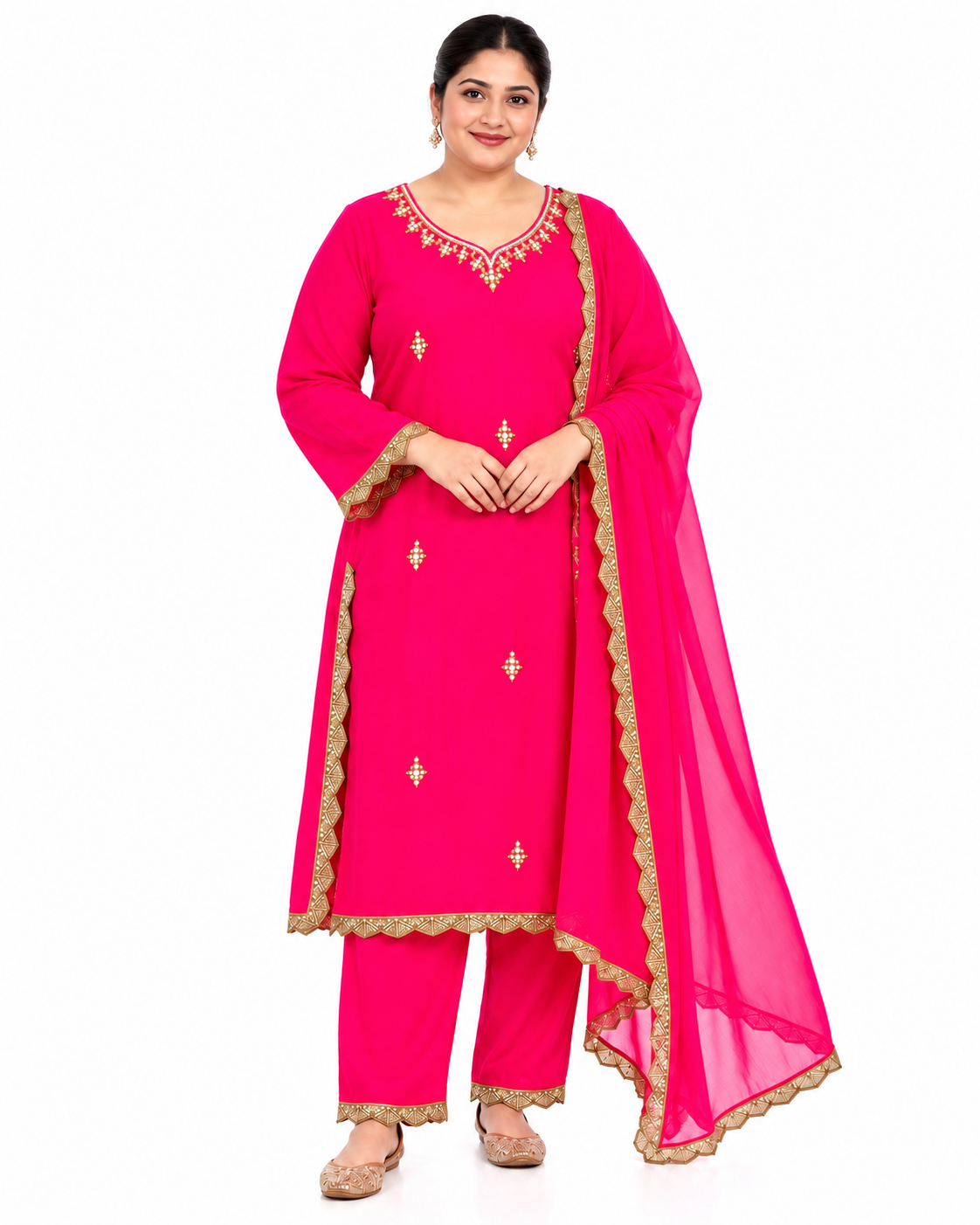 A woman modeling a bright pink traditional Indian salwar kameez suit with gold embroidery and a matching sheer dupatta, set against a plain white background.