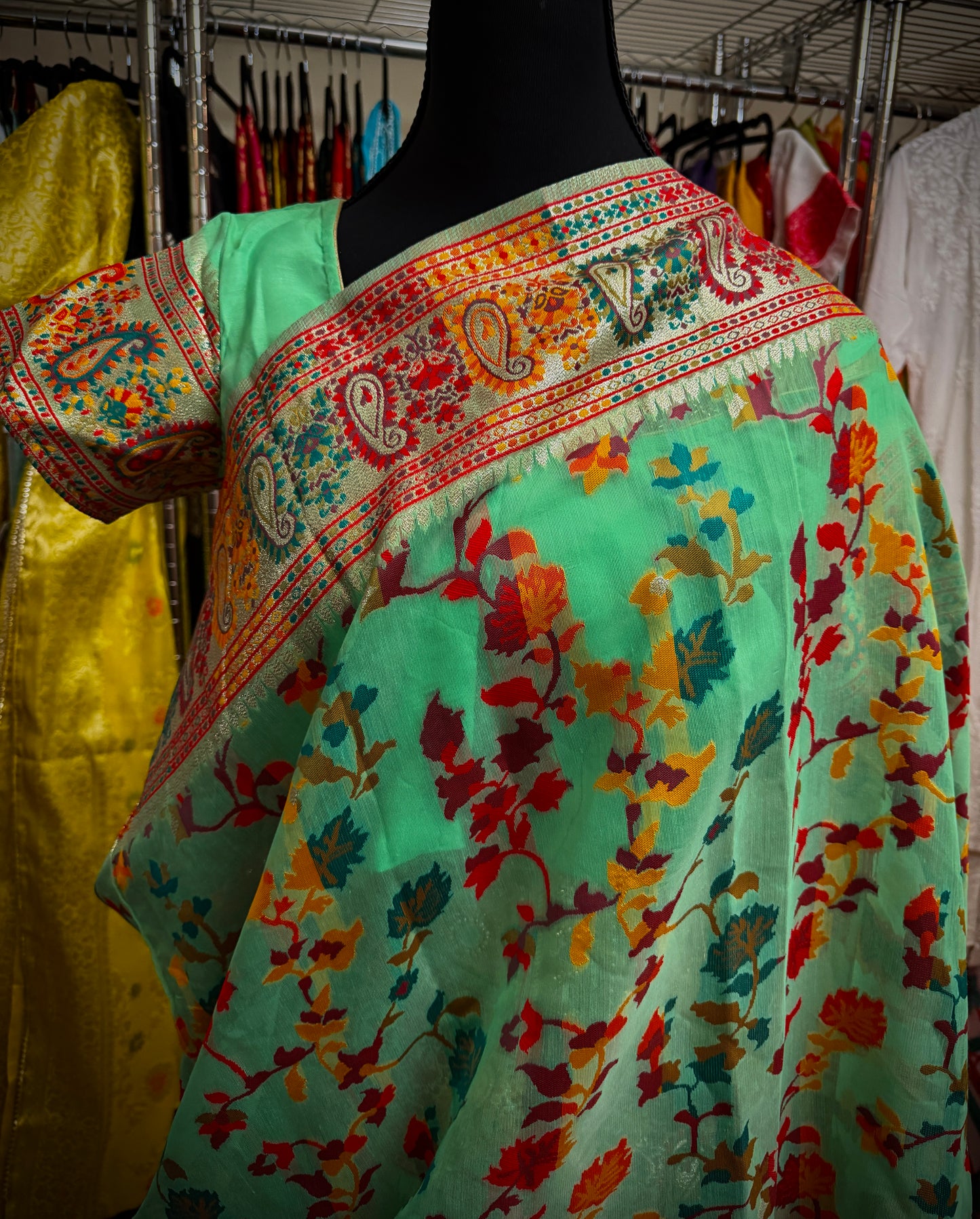 Close-up of the Green Chanderi silk jacquard saree showing intricate woven patterns and colorful traditional detailing.