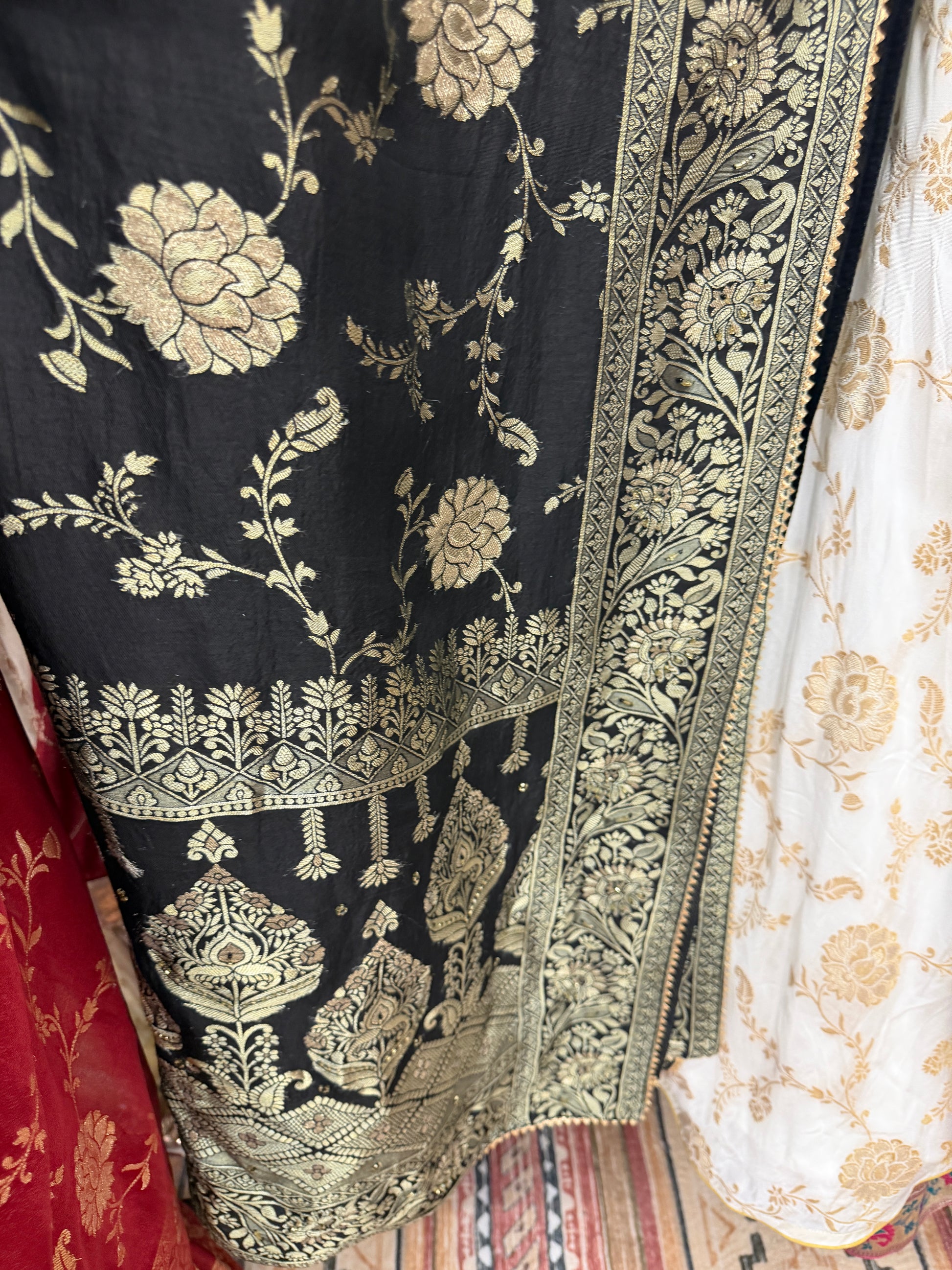 Black and ivory Dola silk saree color combination with traditional zari woven floral border.