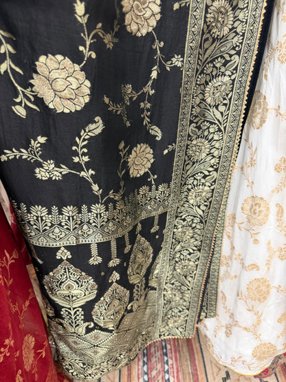 Black and ivory Dola silk saree color combination with traditional zari woven floral border.