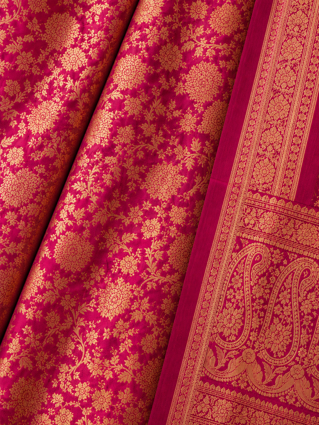 Close-up of Fuchsia Pink Banarasi Silk Saree with Gold Floral Zari Weaving and Green Paisley Border