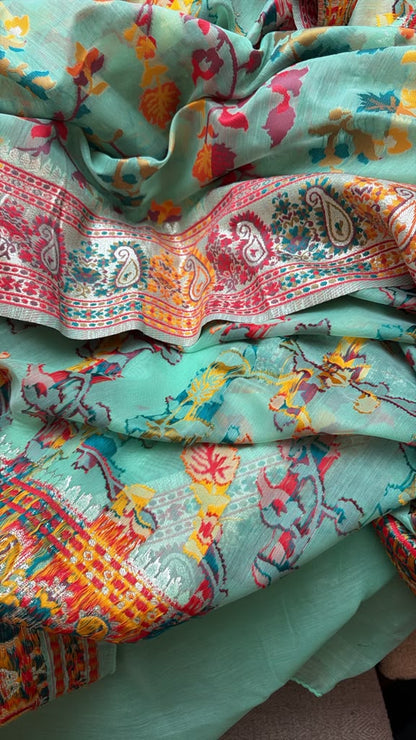 Close-up detail of the colorful woven motifs and patterned pallu on the Green Chanderi silk jacquard saree.