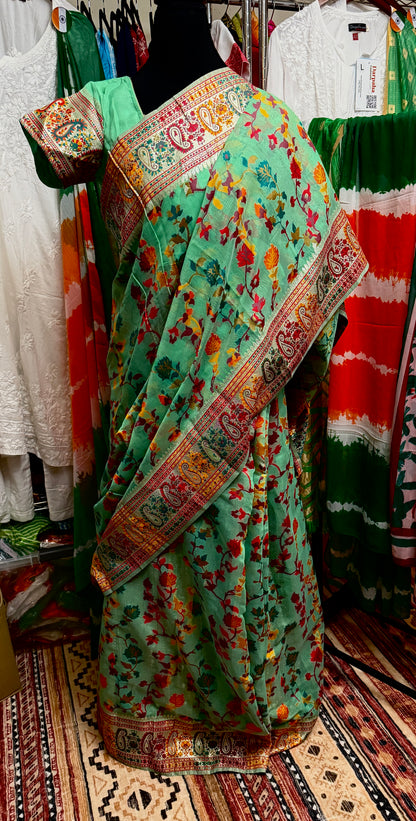 Full-length view of a model wearing the Green Chanderi silk jacquard saree with its coordinated stitched blouse.