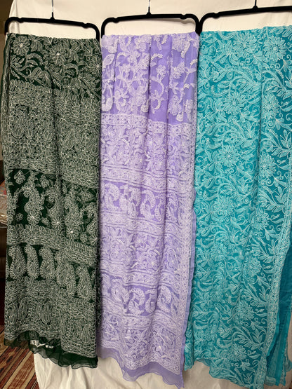 Women's pure georgette embroidered saree collection featuring six elegant colors—green, blue, purple, maroon, dark green, and peach—with intricate white floral embroidery and paisley motifs.