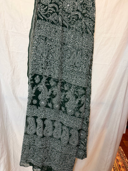 dark green pure georgette saree with detailed white floral embroidery and paisley motifs, styled with a matching embroidered blouse.