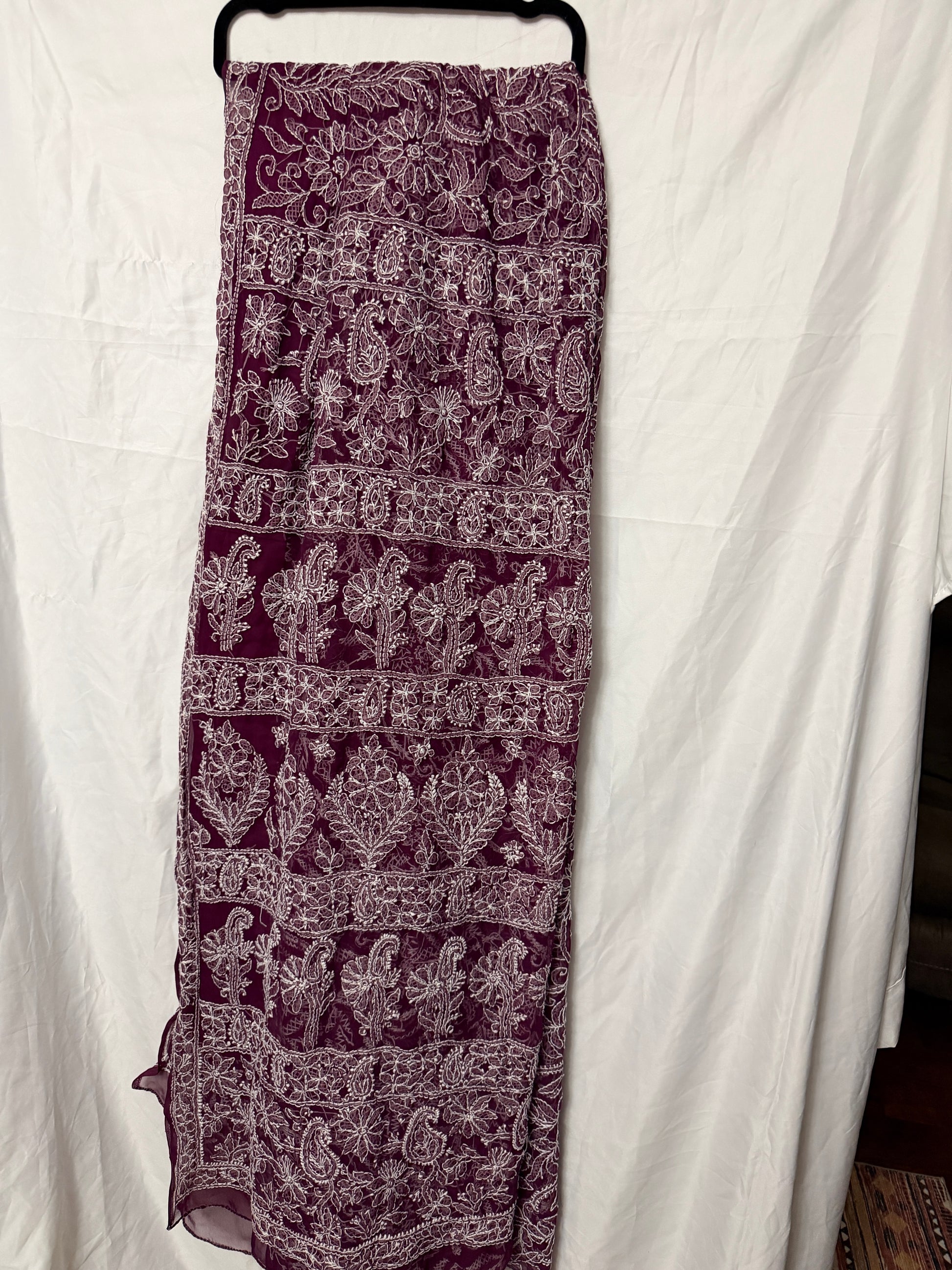 Maroon pure georgette saree featuring delicate white floral embroidery, paisley motifs, and fine embroidered border detailing.