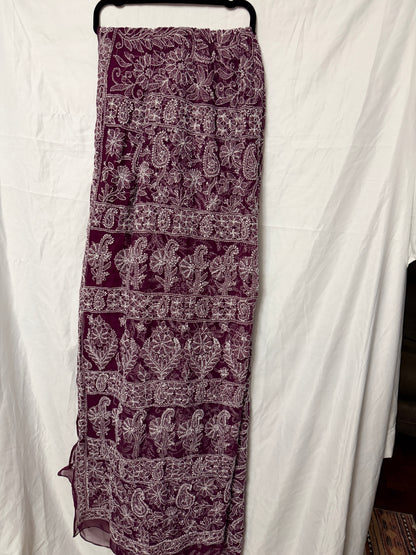 Maroon pure georgette saree featuring delicate white floral embroidery, paisley motifs, and fine embroidered border detailing.