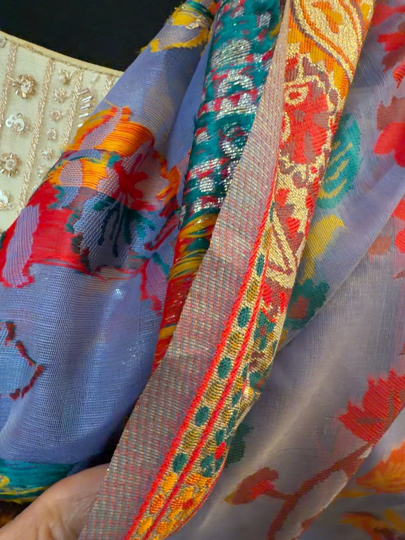 Close-up of the purple Chanderi silk jacquard saree showing intricate woven patterns and colorful traditional detailing.
