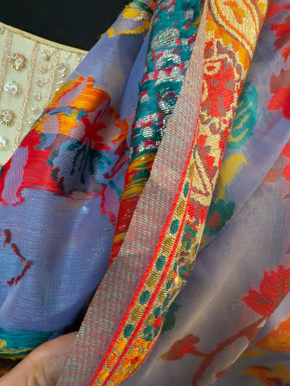 Close-up of the purple Chanderi silk jacquard saree showing intricate woven patterns and colorful traditional detailing.