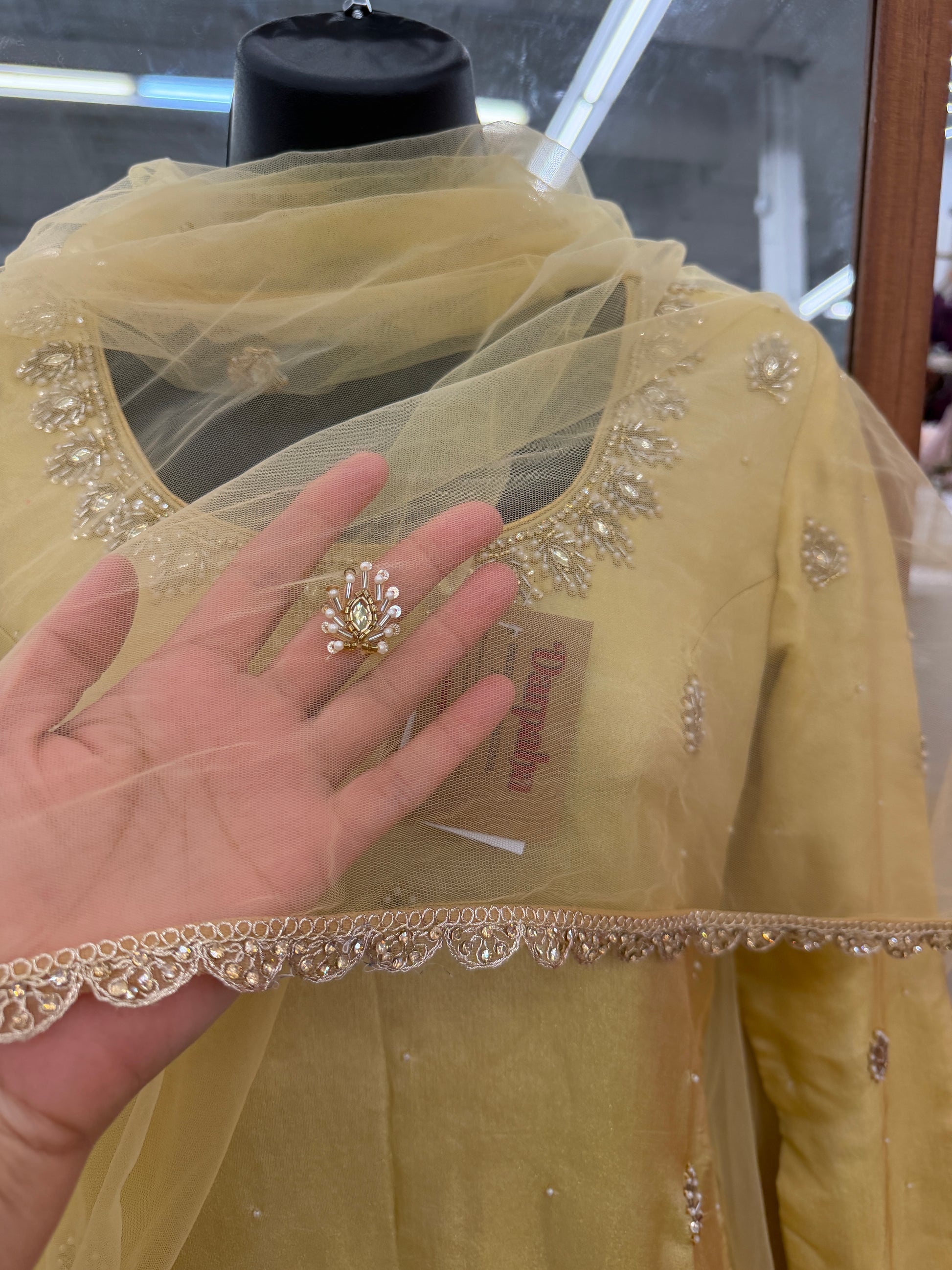 Close-up of hand embroidery and traditional Gota Work on mustard yellow Chinon dupatta
