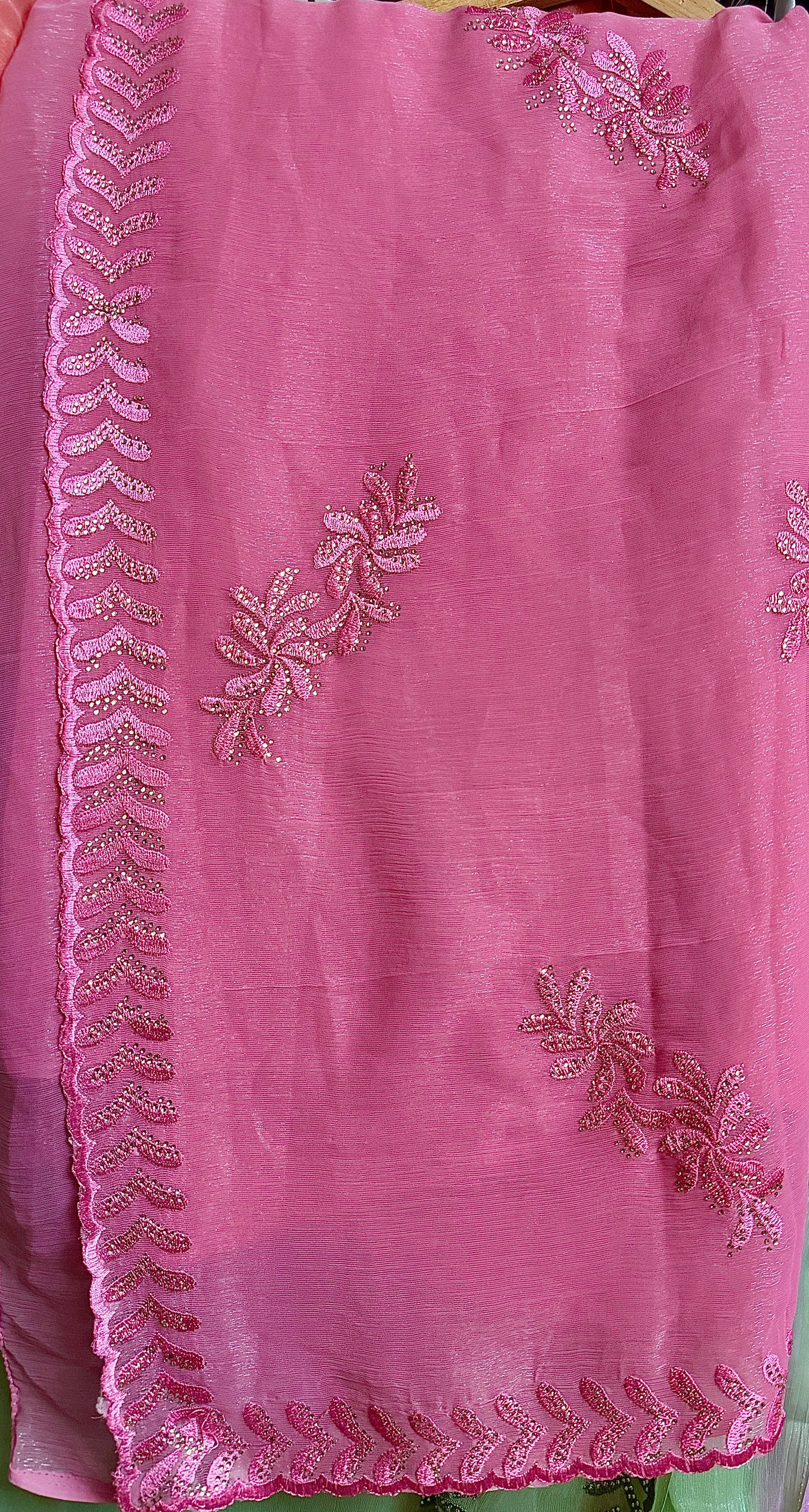 Close-up of blush pink shimmer tissue chiffon saree fabric with subtle shine