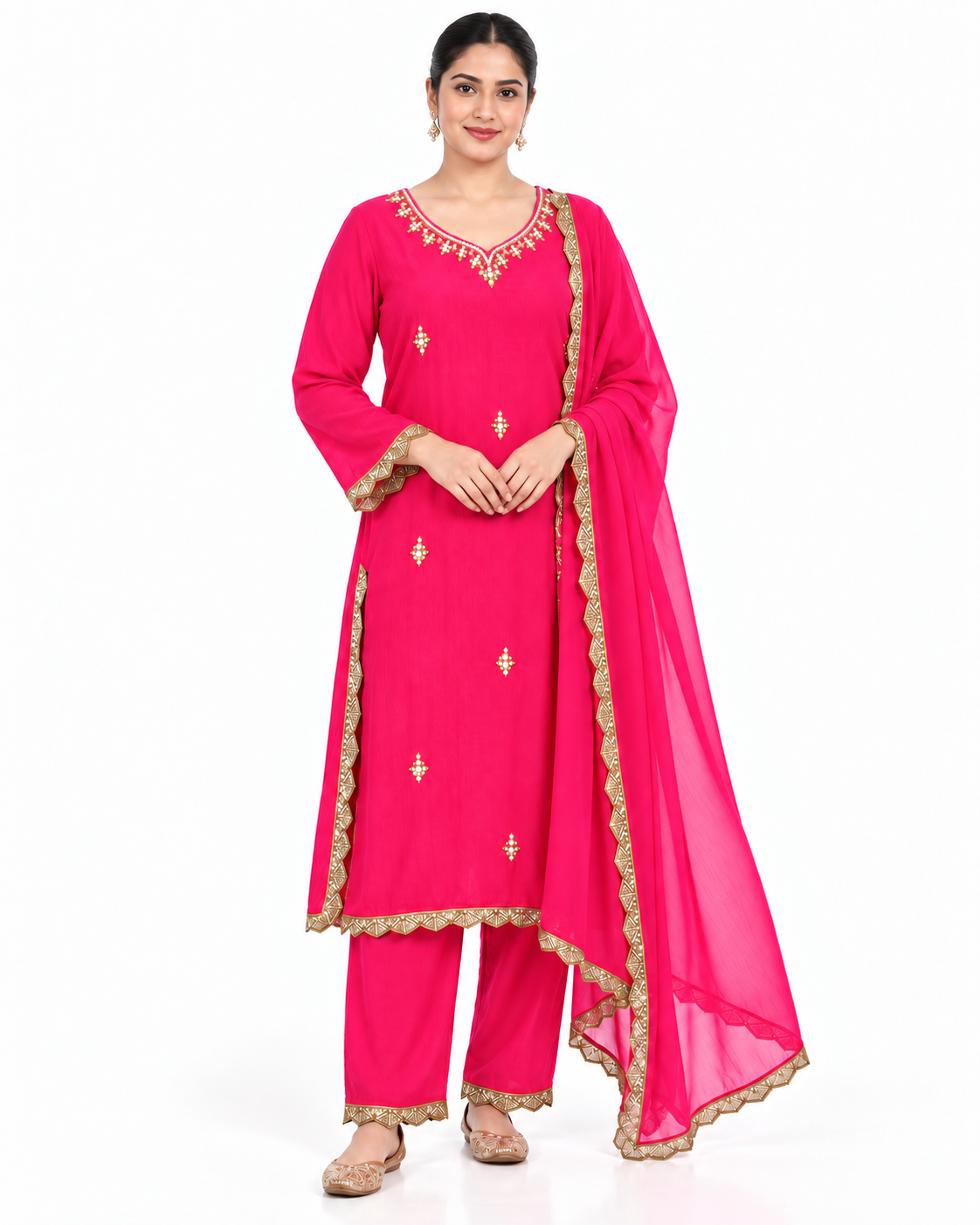 A woman modeling a bright pink traditional Indian salwar kameez suit with gold embroidery and a matching sheer dupatta, photographed against a plain white background.