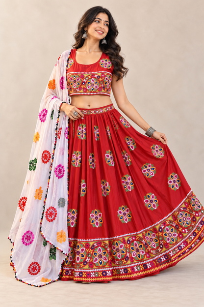 AI model wearing a red chaniya choli with a full rayon lehenga, colorful mirror-work embroidery, broad hem border, and multicolor chiffon dupatta.
