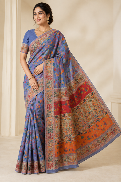 Woman wearing a purple Chanderi silk jacquard saree featuring multicolor woven floral motifs, a Banarasi-style border, and an orange-red woven pallu with a matching blouse.