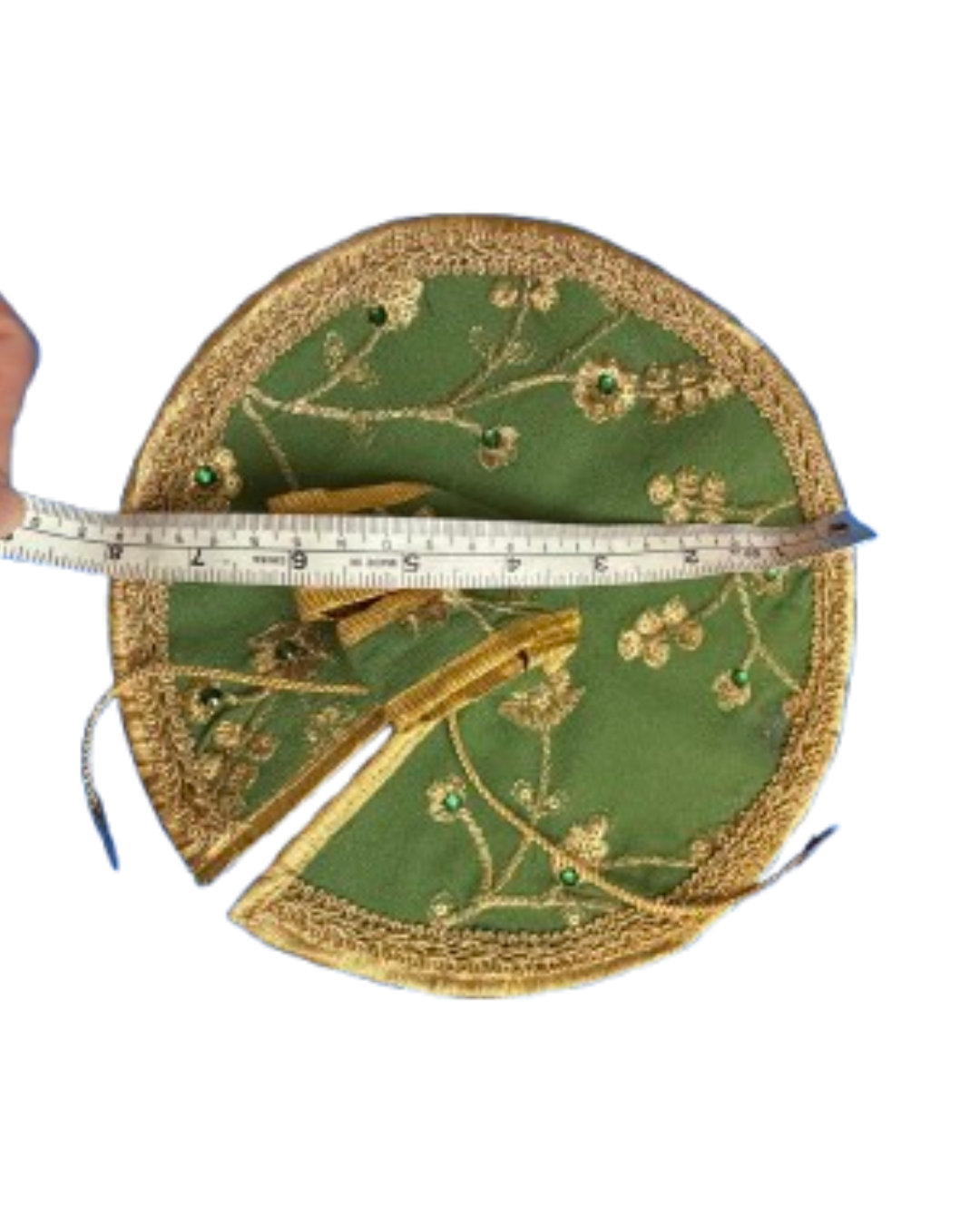 Green and gold Laddu Gopal poshak shown with measuring tape to indicate its size