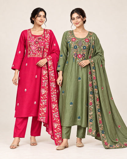 Two women modeling traditional Indian salwar kameez suits. The woman on the left wears a bright pink suit with floral embroidery and a matching dupatta.