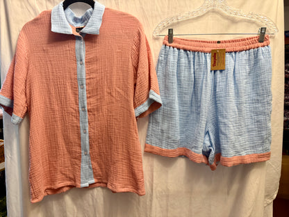 Women's muslin cotton pajama set with dusty rose button-front shirt and matching powder blue elastic-waist shorts.