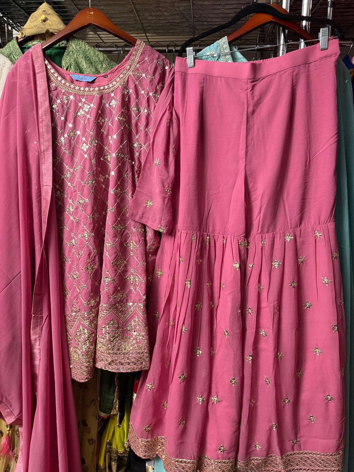 Pink Georgette embroidered Sharara suit set displayed on a hanger