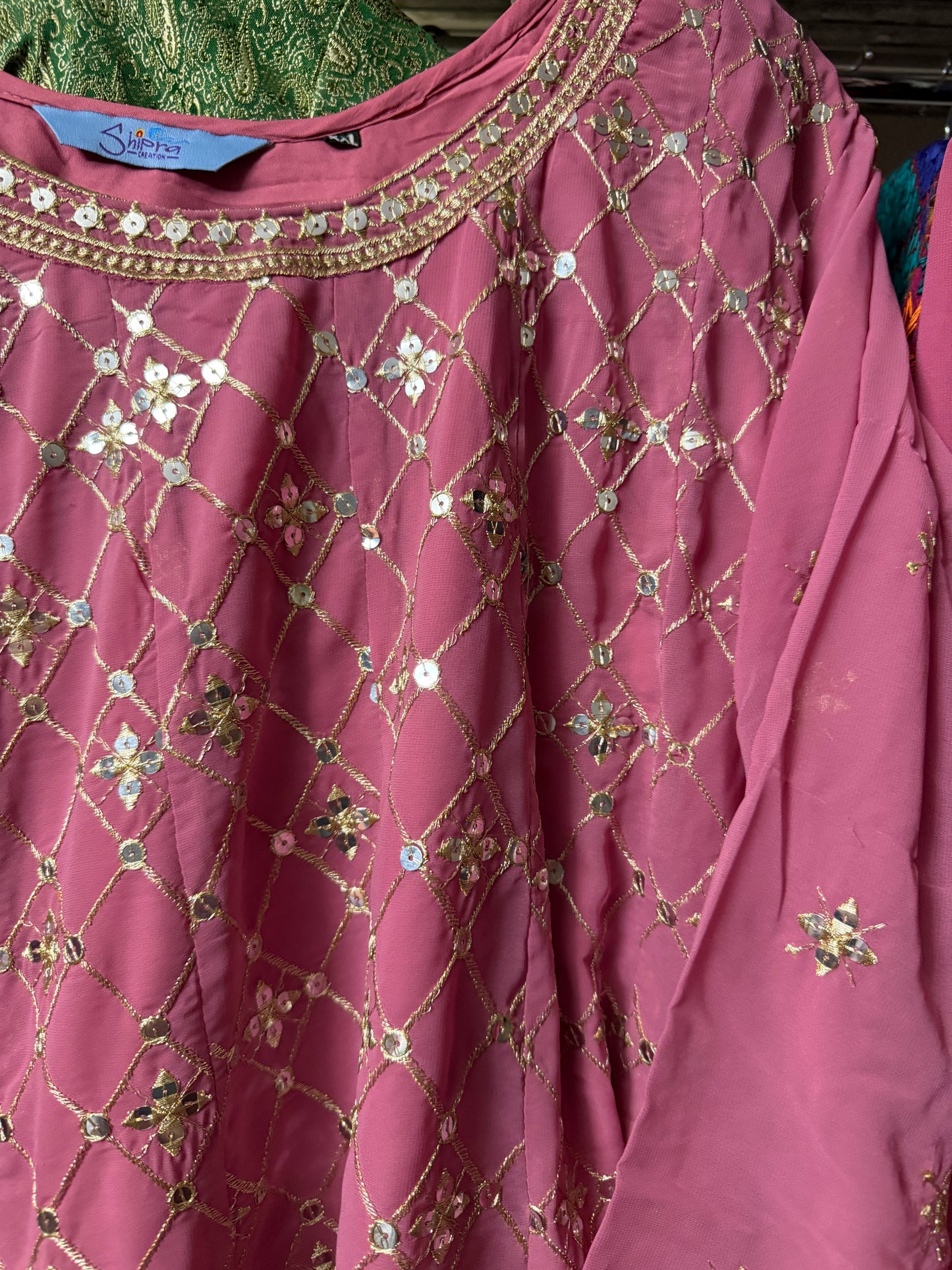 Close-up of pink Georgette kurti showing intricate sequin and zari embroidery