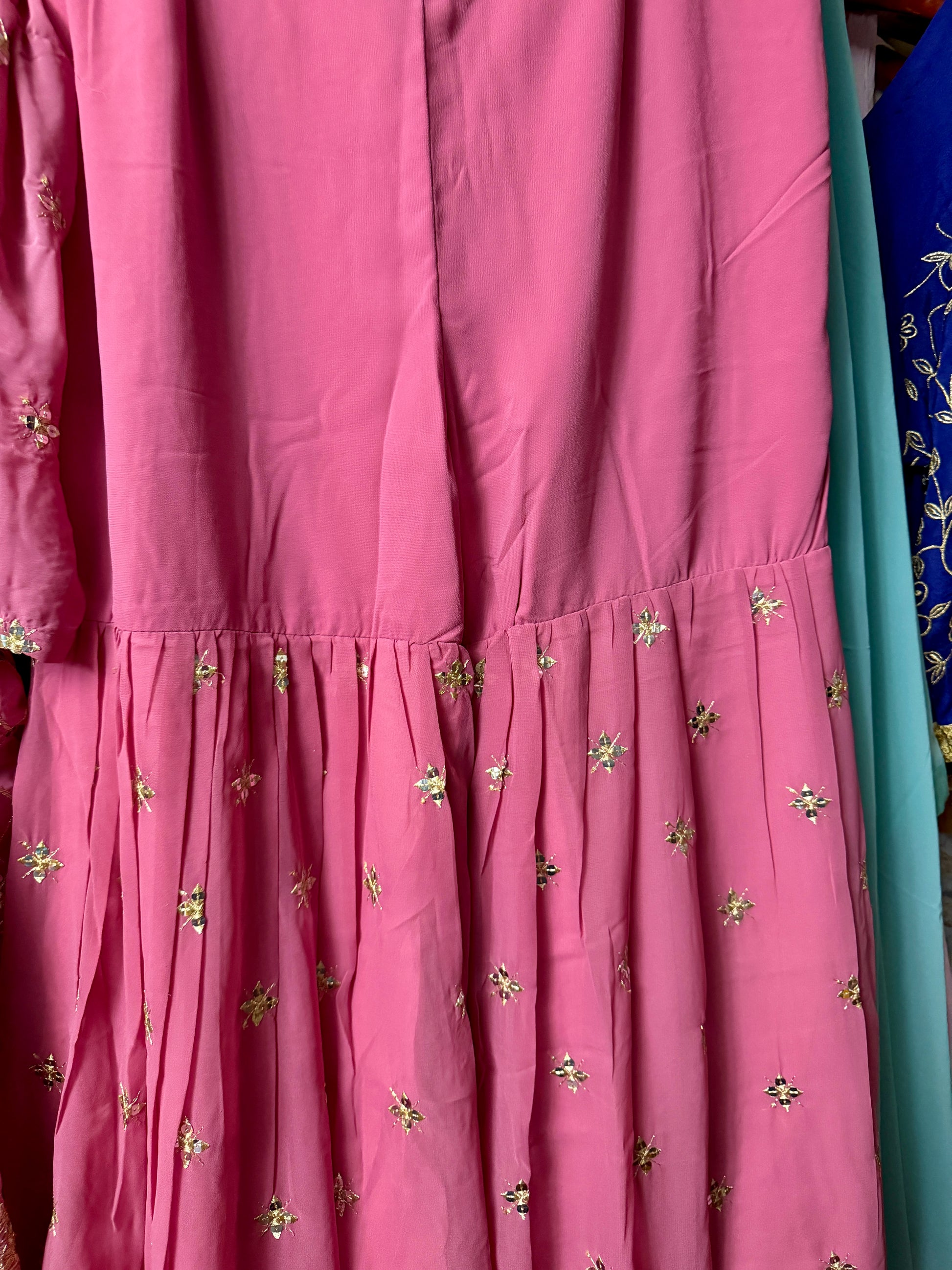 Close-up of pink Georgette Sharara showing embroidered tier and decorative hem