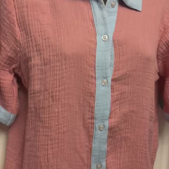 Video of Muslin cotton pajama set with powder blue shorts and a button-front shirt.