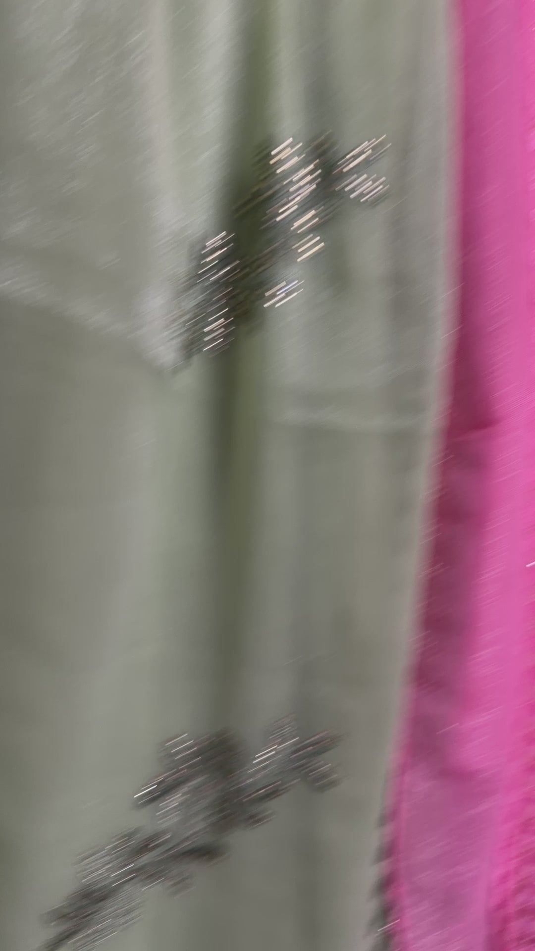 Close-up of a pistachio-green, lavender, and blush-pink shimmer tissue chiffon saree showing its soft sheen and fabric texture