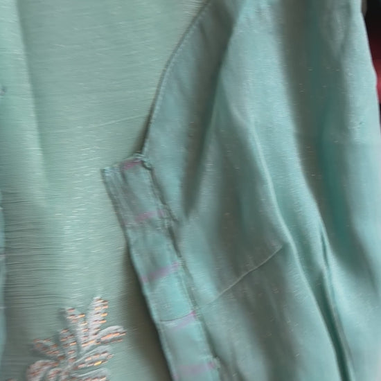 Close-up of teal and peach shimmer tissue chiffon saree showing its soft sheen and fabric texture