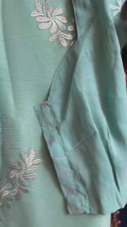 Close-up of teal and peach shimmer tissue chiffon saree showing its soft sheen and fabric texture
