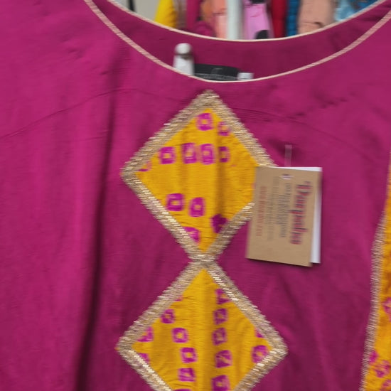 Close-up of the geometric embroidered neckline and detailing on the magenta Punjabi Patiala salwar suit.