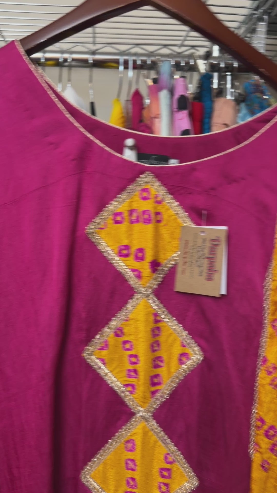 Close-up of the geometric embroidered neckline and detailing on the magenta Punjabi Patiala salwar suit.