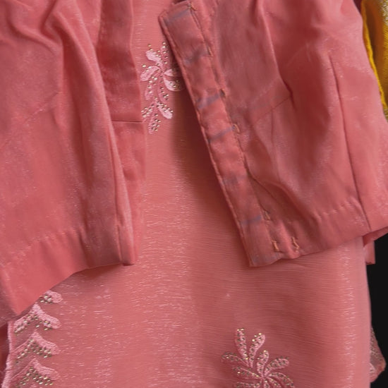 Close-up of peach shimmer tissue chiffon saree fabric showing its soft luminous finish