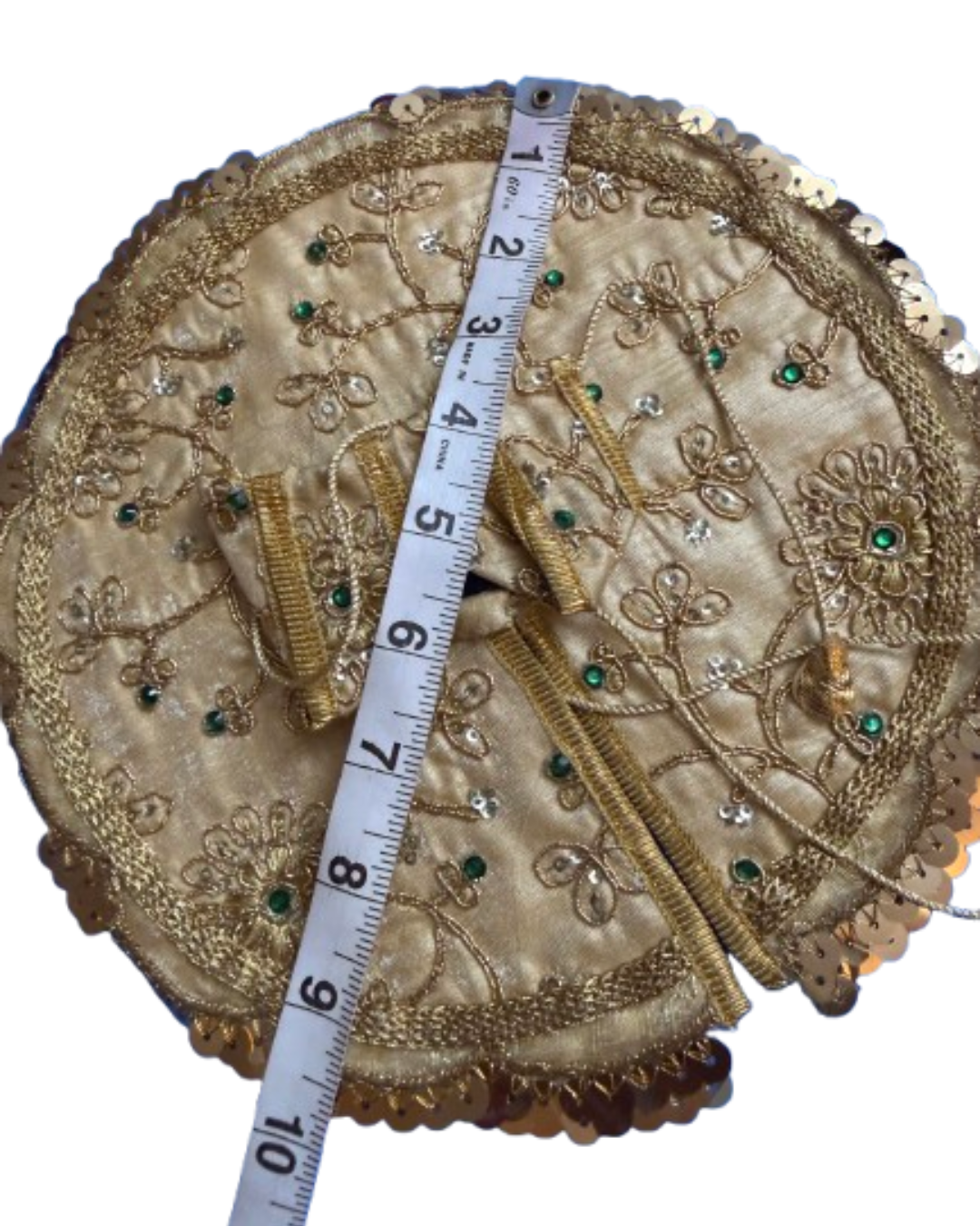 Silver and gold Laddu Gopal poshak shown with measuring tape to indicate size