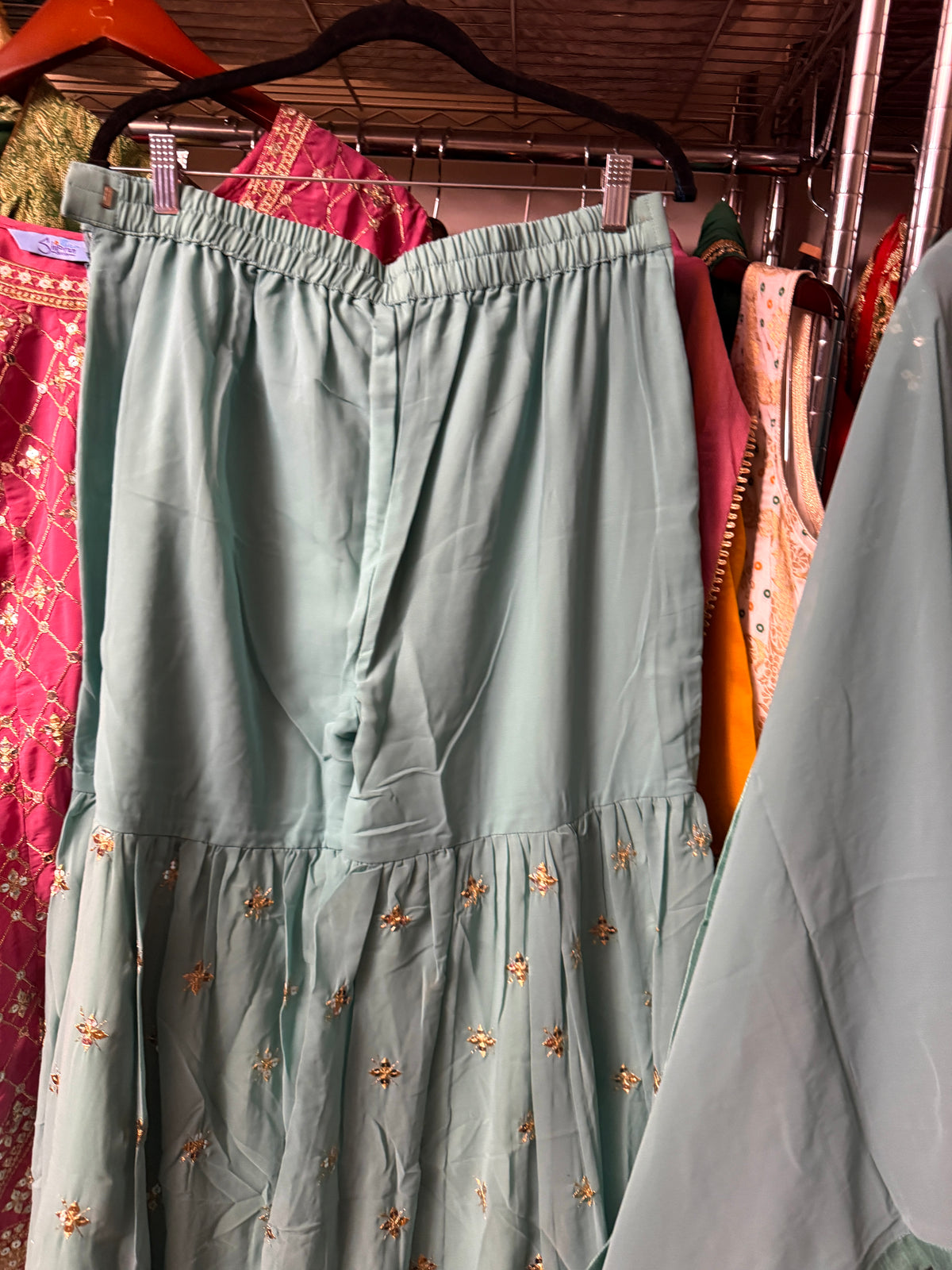 Teal Georgette embroidered Sharara suit set displayed on a hanger