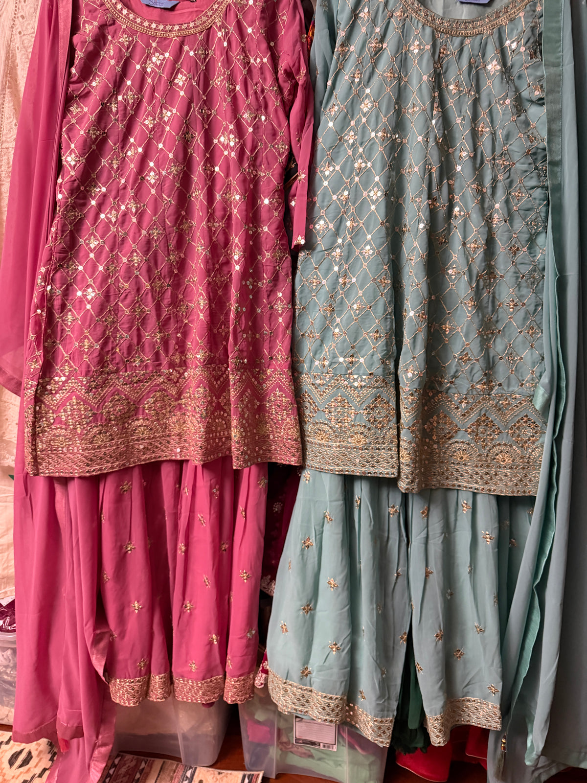 Teal and pink Georgette Sharara suit pieces displayed together showing embroidered details