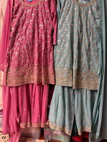 Teal and pink Georgette Sharara suit pieces displayed together showing embroidered details