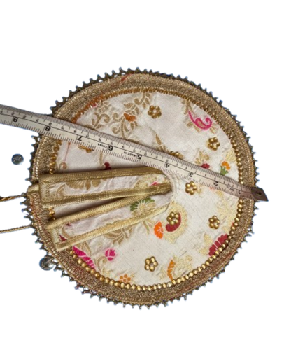 Ivory and gold Laddu Gopal poshak shown with measuring tape for size reference